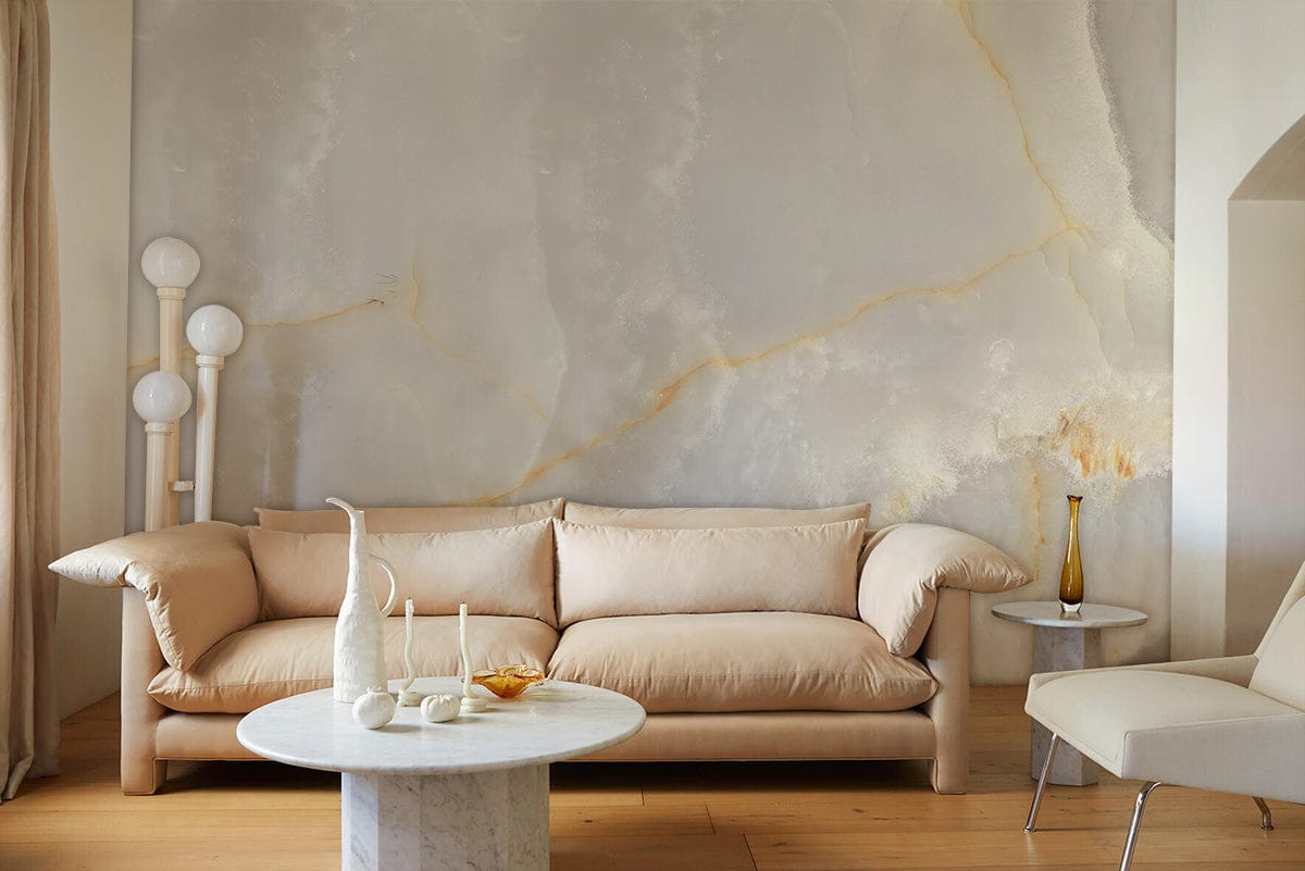 Luxurious marble-effect wallpaper, white and gold design, complements beige sofa and marble coffee table.
