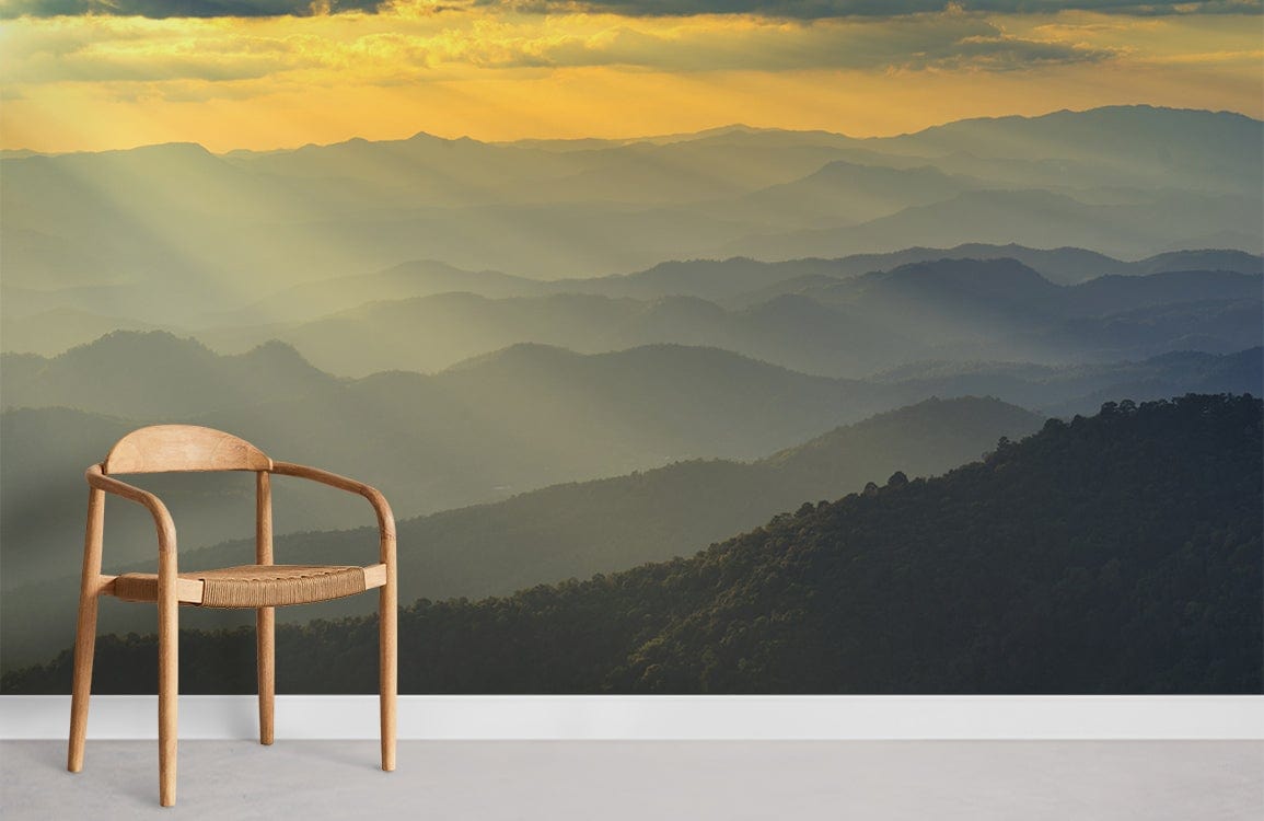Amber sunset mountain mural wallpaper beside wooden chair on light floor in serene living room.