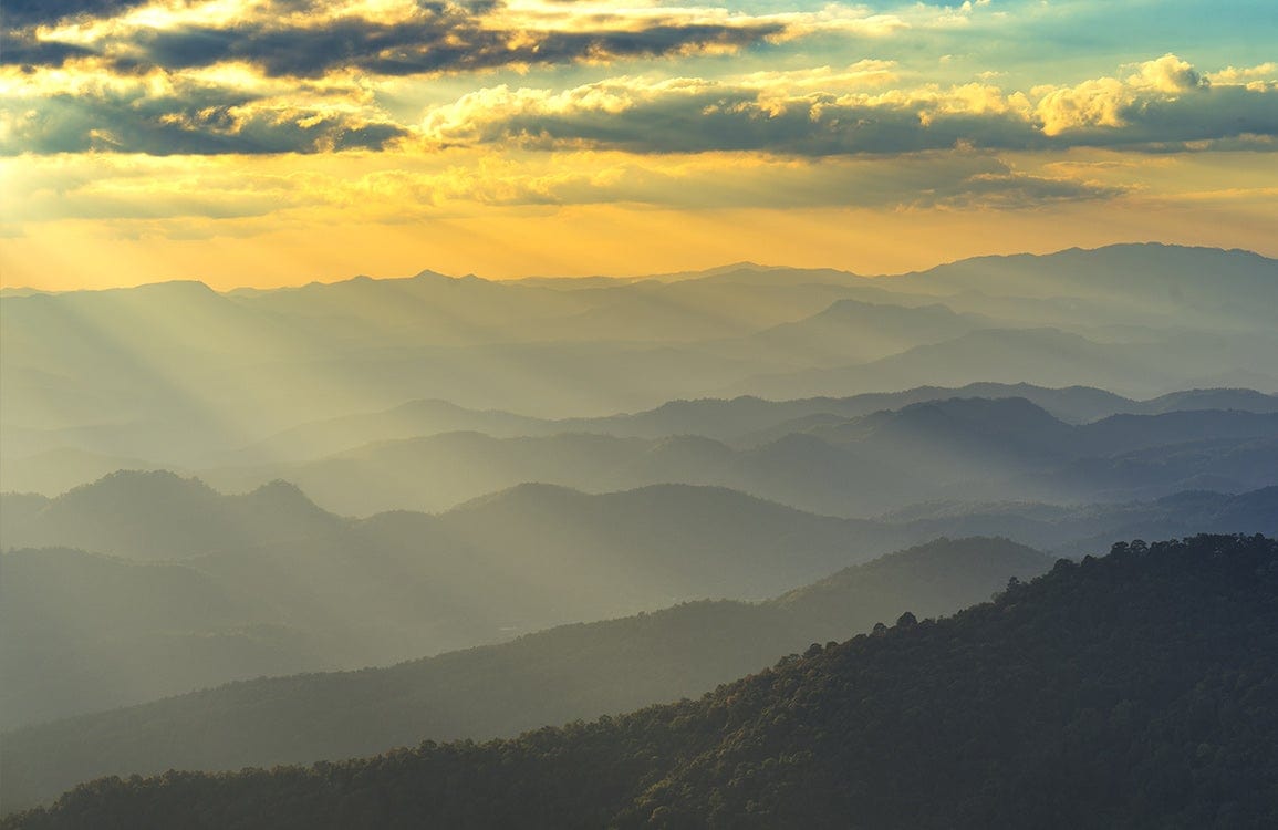 Serene Sunset Mountain Landscape Mural Wallpaper in Golden Amber Tones