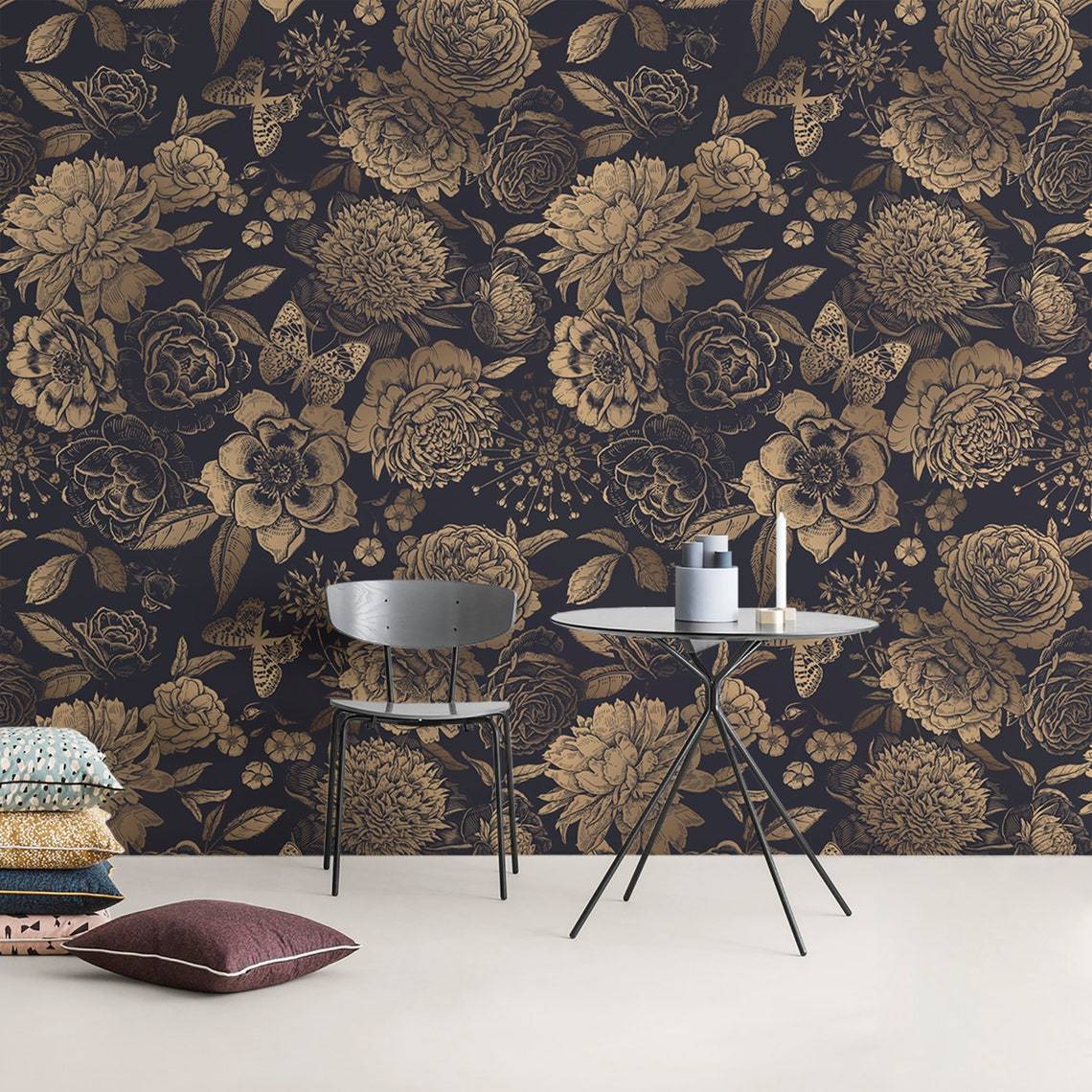 Luxurious gold floral damask wallpaper with navy background, featuring modern chair, sleek round table.