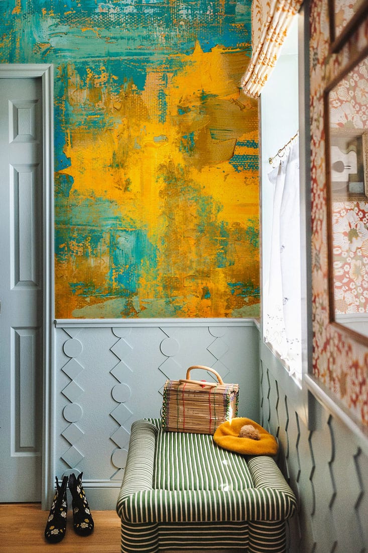 Colourful Abstract Brush Stroke Teal Yellow Mural Wallpaper, hallway with striped bench, and shoes.
