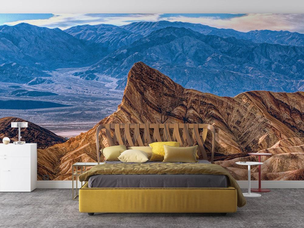 Contemporary bedroom with Desert Mountain Vista Mural, earthy tones, modern bed, grey carpet flooring.