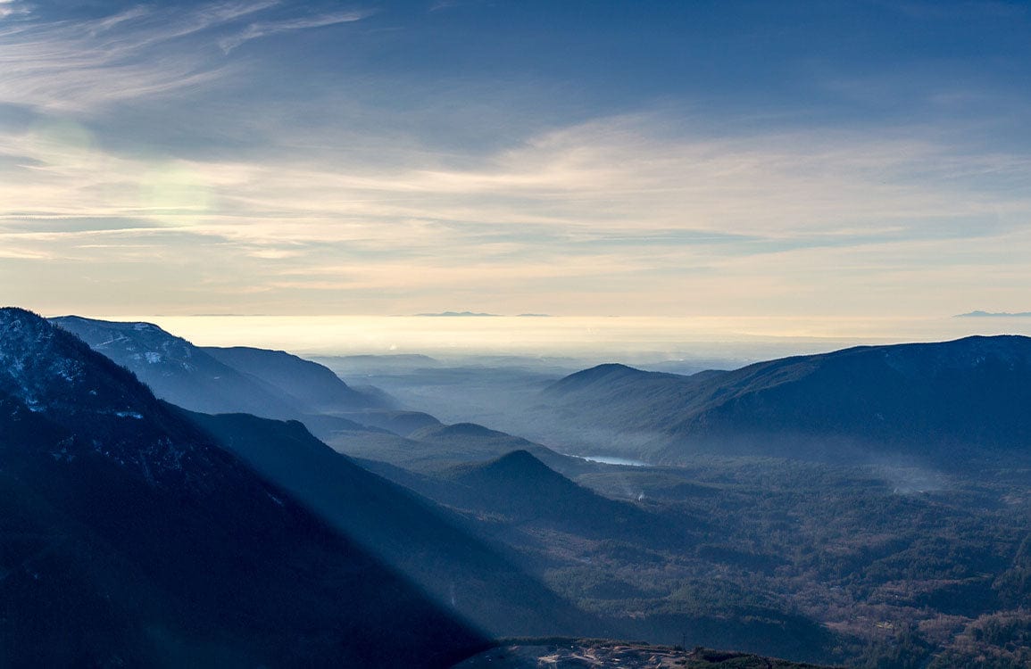 Tranquil Mountain Vista Mural Wallpaper in Serene Blue Tones