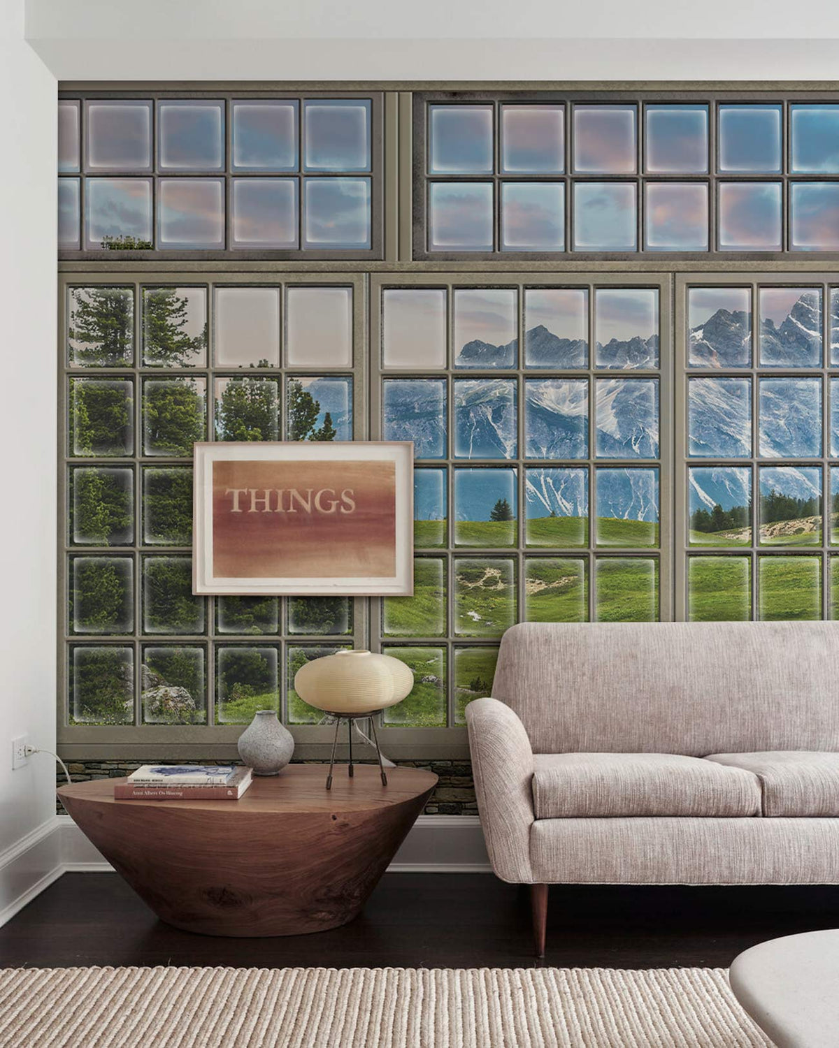 Panoramic Mountain View Mural Wallpaper with beige sofa, wooden side table, dark wood flooring, modern room.