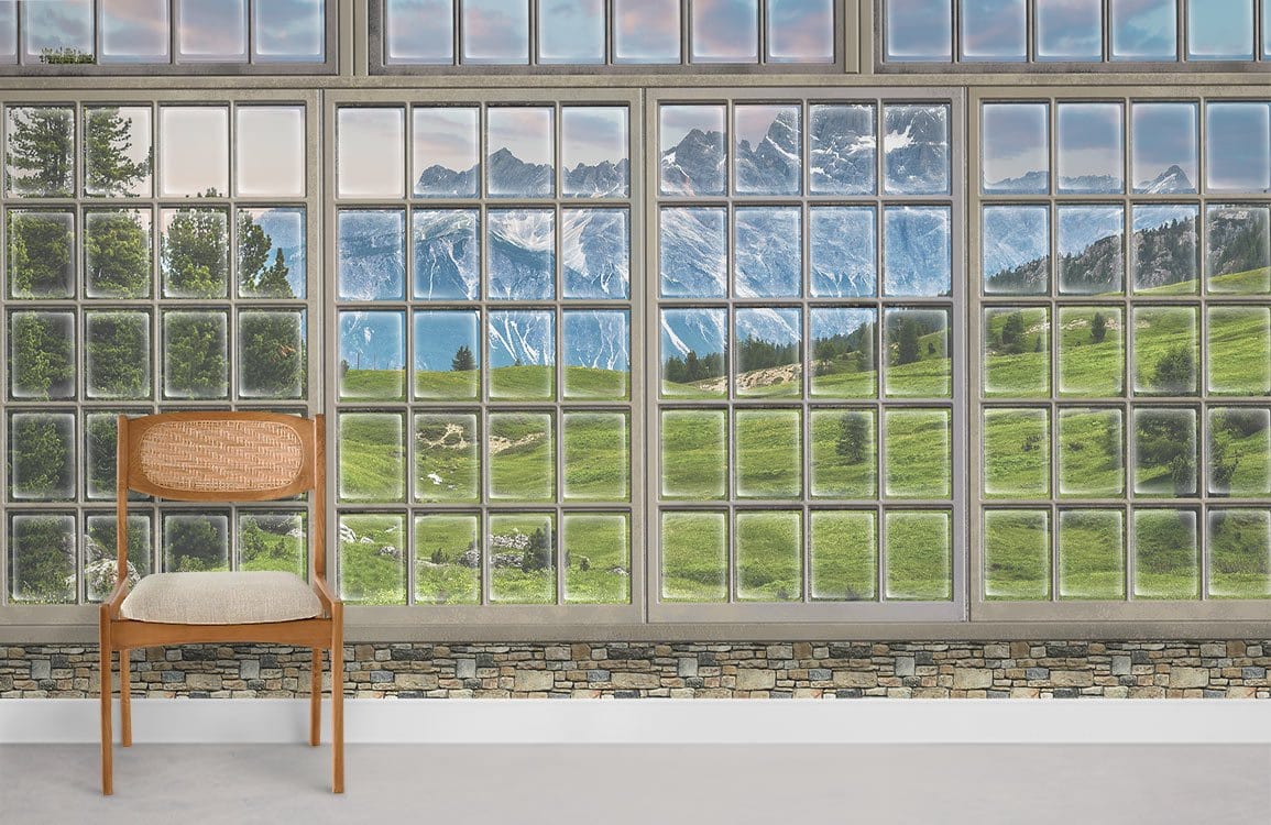 Panoramic mountain view mural wallpaper in room with wooden chair and stone accent wall. Scenic landscape.