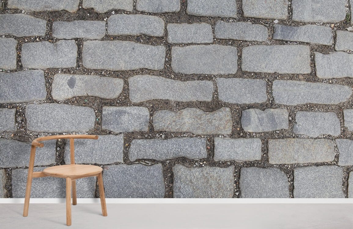 Rustic grey cobblestone wallpaper with wooden chair, complements vintage stone decor in modern room setting.