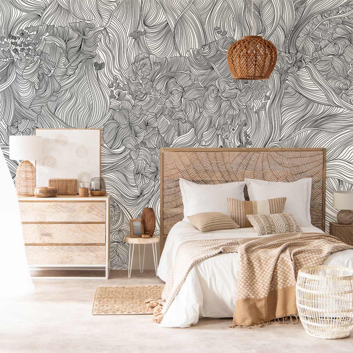 Monochrome floral wallpaper in bedroom with wicker bed, light wood furniture, and rustic decor accents.