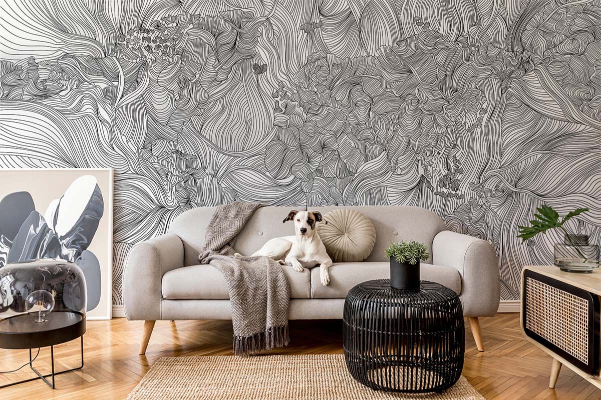 Monochrome Floral Fantasy wallpaper in living room with grey sofa, parquet flooring, elegant black decor.