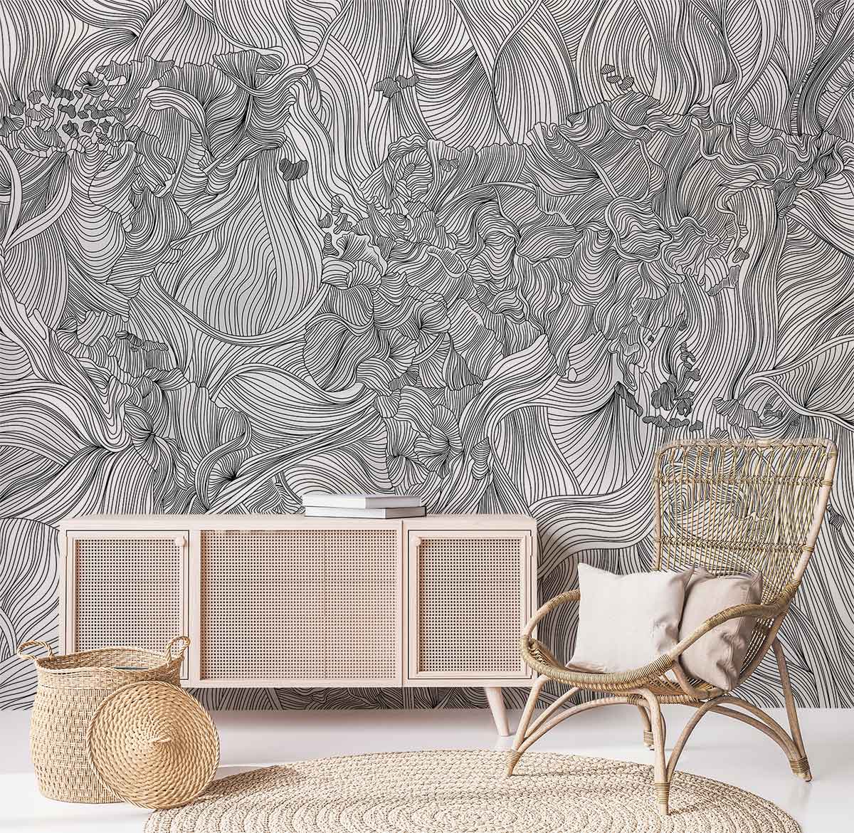 Monochrome Floral Fantasy wallpaper with wicker chair, light wood cabinet, and woven rug in living room.