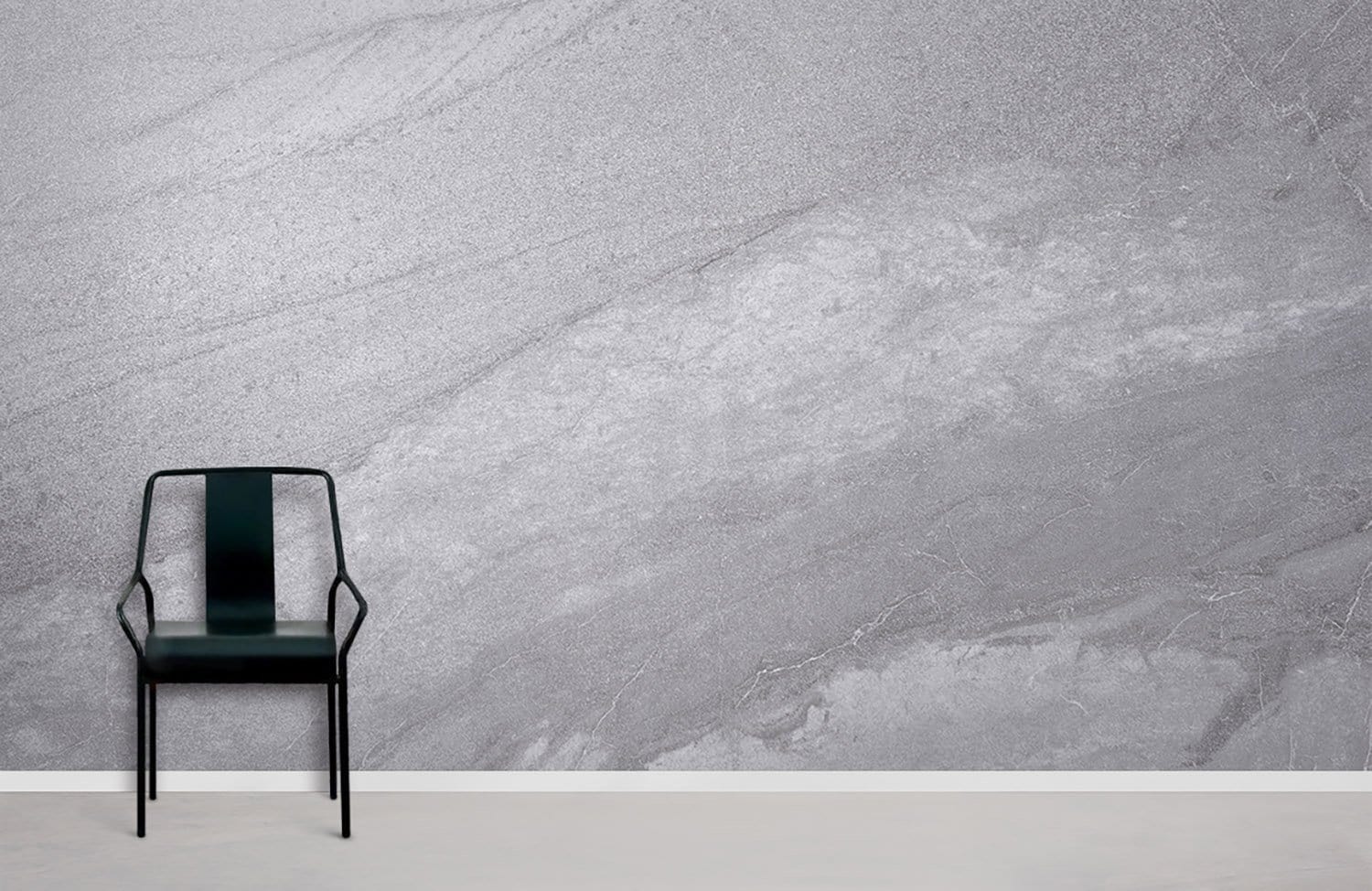 Elegant grey marble wallpaper in modern room with black chair and light grey flooring.