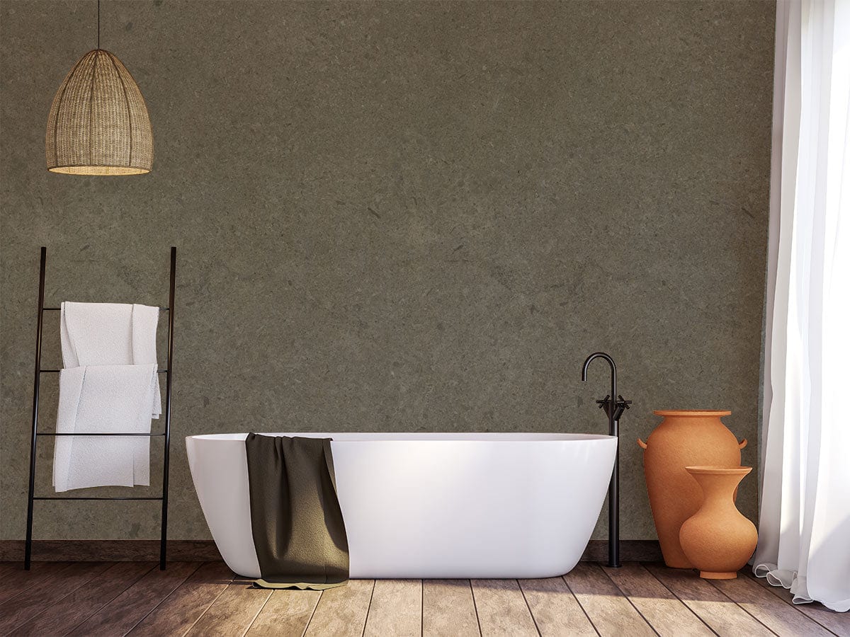 Textured Slate Grey Stone Effect Wallpaper in modern bathroom, featuring white bathtub and wooden flooring.