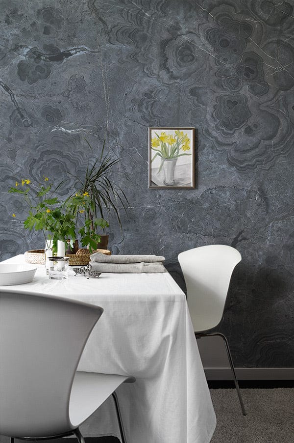 Elegant charcoal marble wallpaper in dining room with modern white chairs, grey flooring, and artwork.