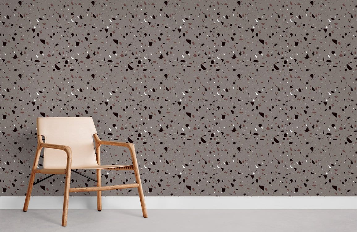 Modern grey terrazzo-style speckled wallpaper with beige chair, chic interior design solution for living room.
