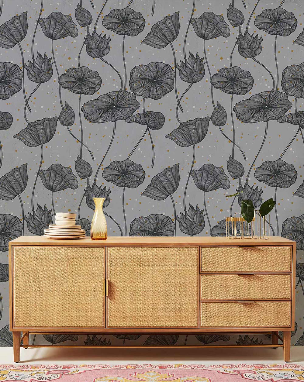 Grey botanical floral wallpaper with elegant leaf design; light wood sideboard; living room decor.