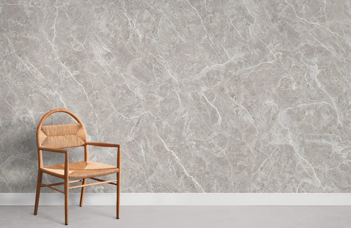 Elegant grey marble effect textured wallpaper with wooden chair, modern interior design, light flooring.