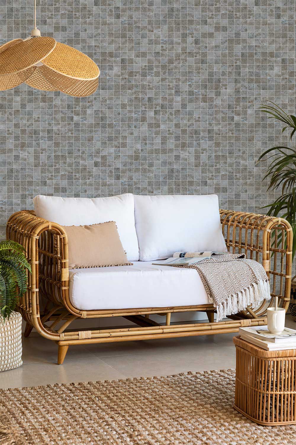 Elegant grey mosaic tile wallpaper behind rattan sofa in modern living room with neutral rug.