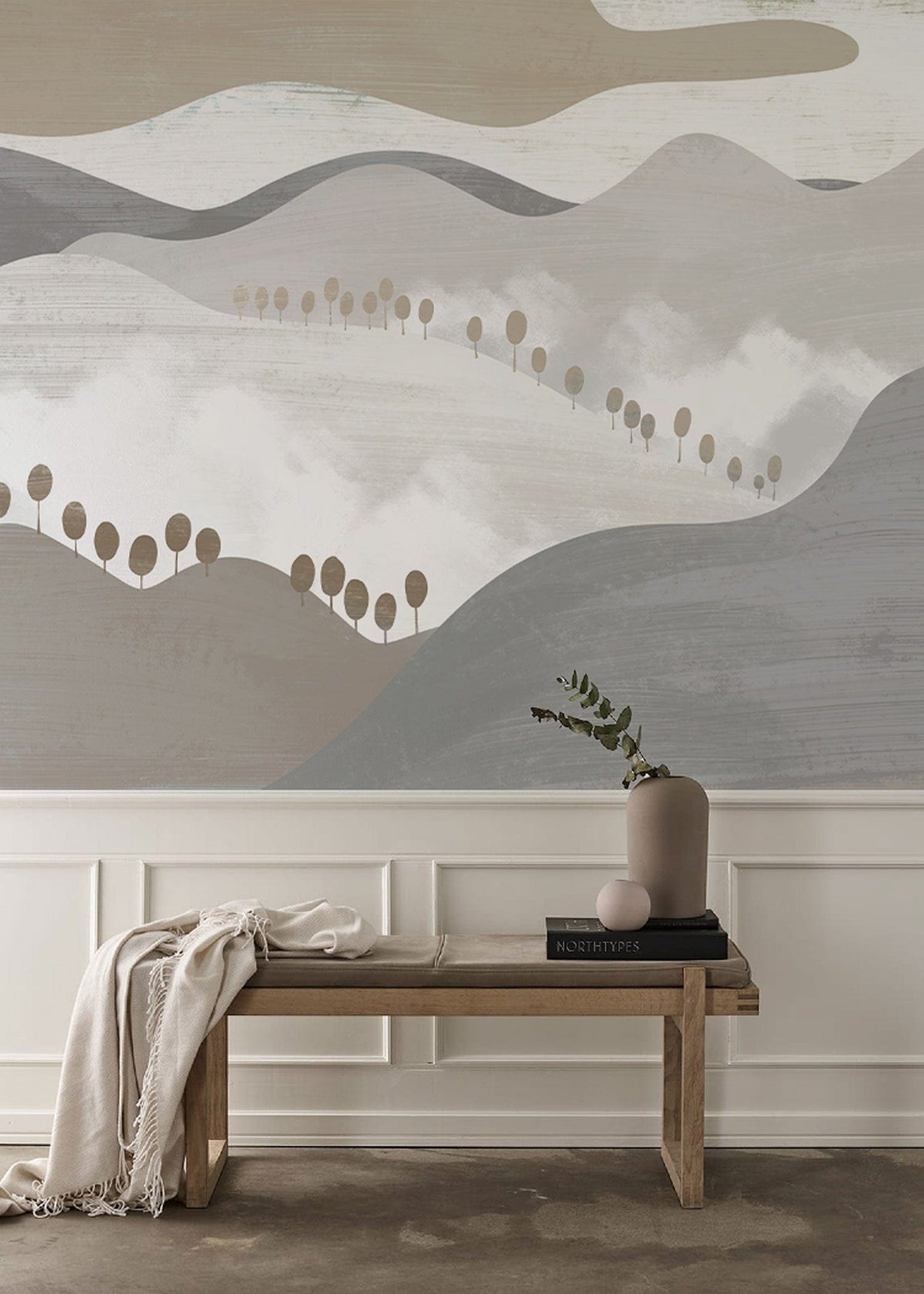 Abstract mountain landscape mural with elegant bench; serene neutral tones; hardwood flooring complements style.