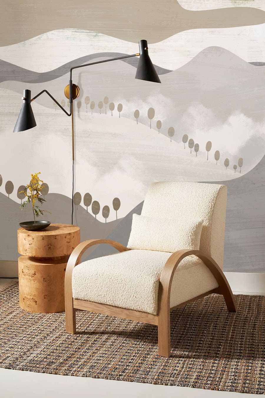 Cream armchair, modern floor lamp, abstract mountain mural wallpaper in calming neutral shades, textured rug.