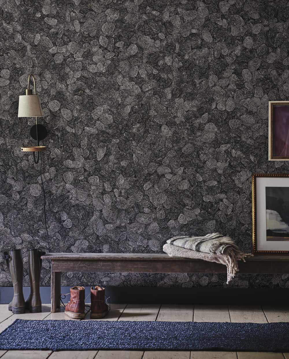 Elegant grey pebble textured wallpaper, wooden bench, rustic flooring, wall lighting, framed artwork, hallway.