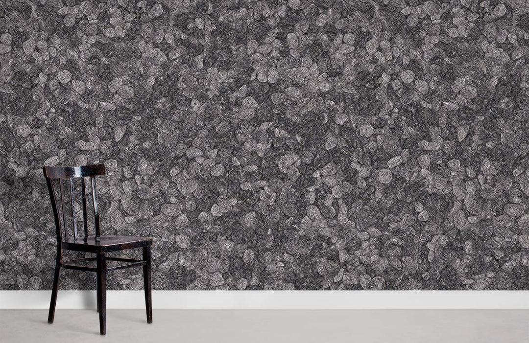 Elegant grey pebble textured wallpaper with dark wooden chair in minimalist room setting.