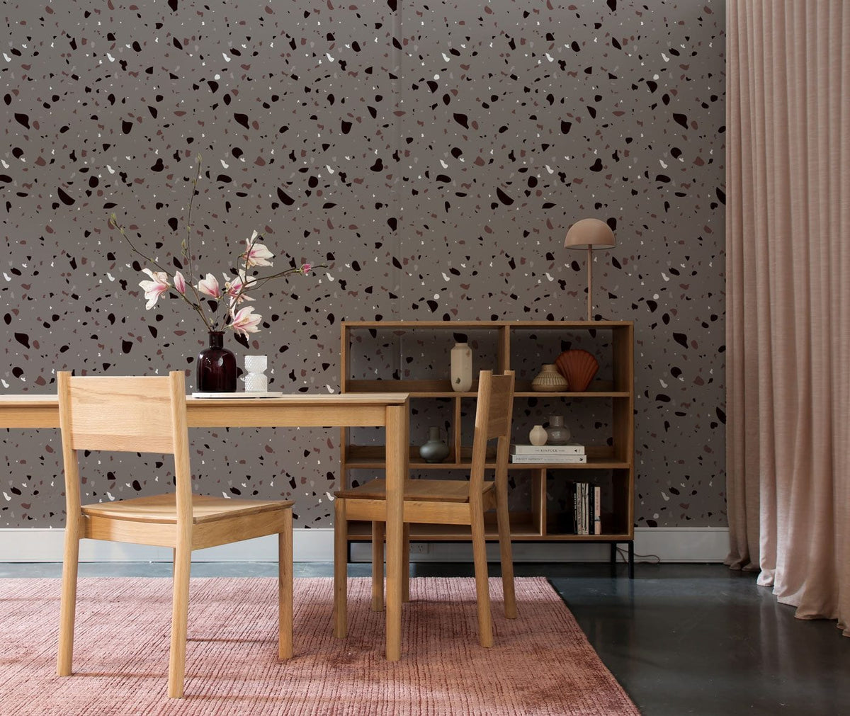 Modern Grey Terrazzo Wallpaper in dining room with wooden furniture, pink rug, and grey flooring.