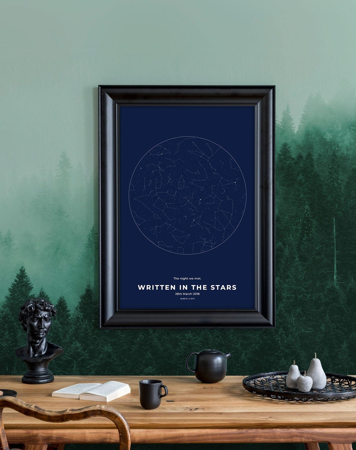 Emerald Mist Forest Landscape mural in living room with wooden table, framed art, black details.