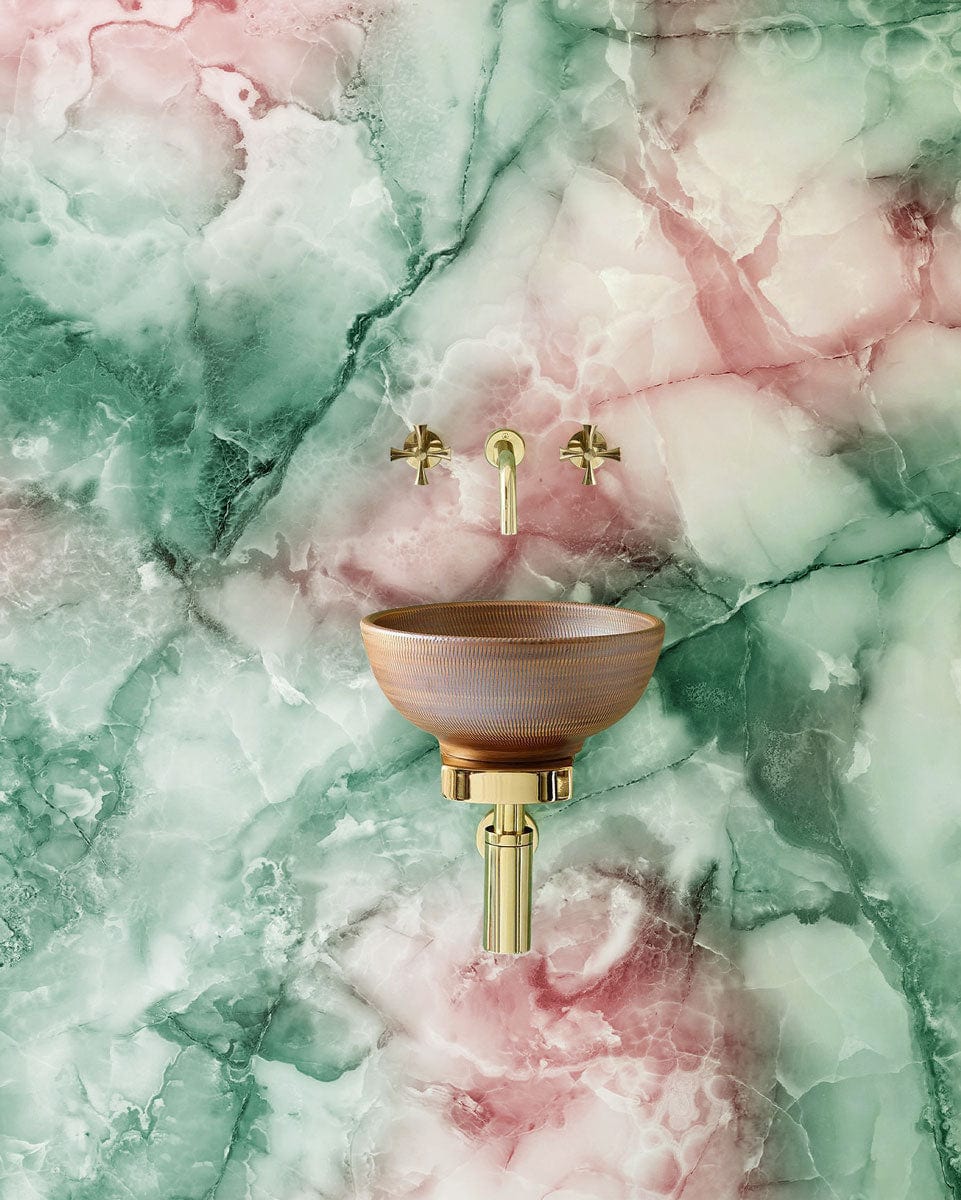 Marble effect wallpaper mural in green and pink, featuring round sink and gold tap fittings.