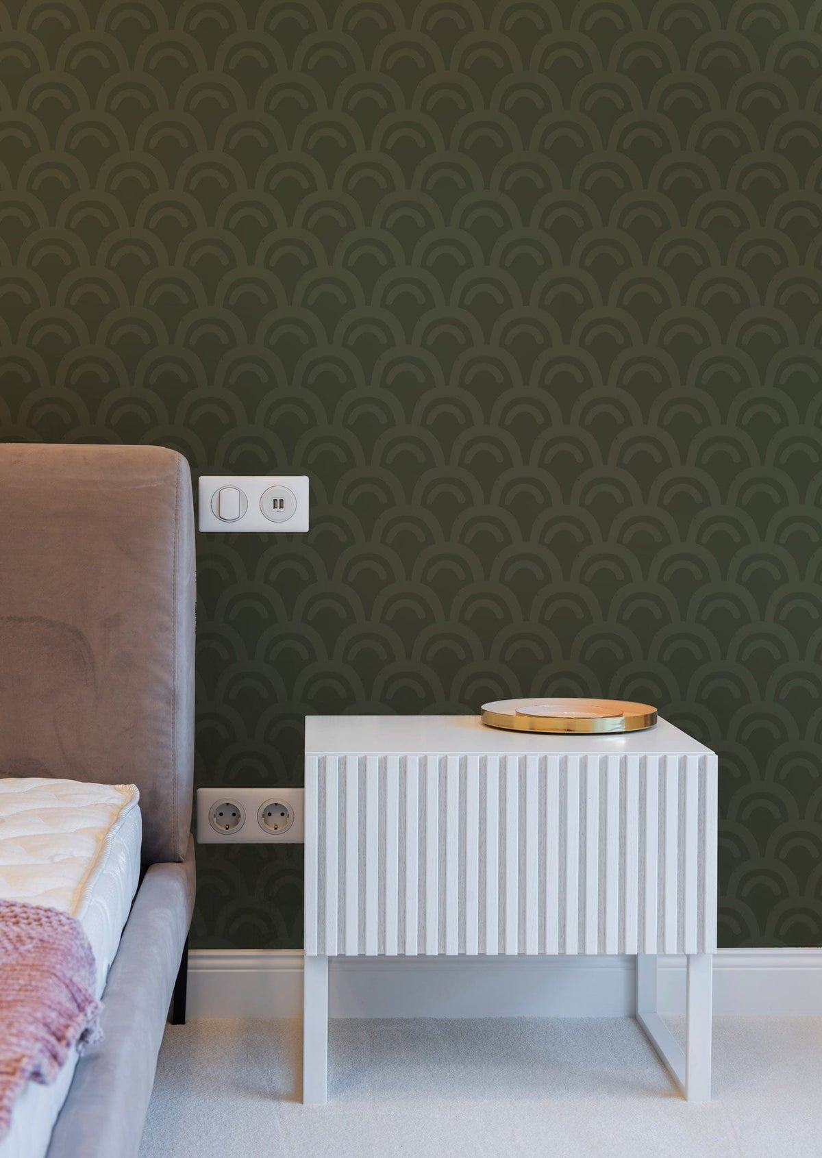 Elegant Green Art Deco wallpaper with beige sofa, white side table in stylish bedroom setting.