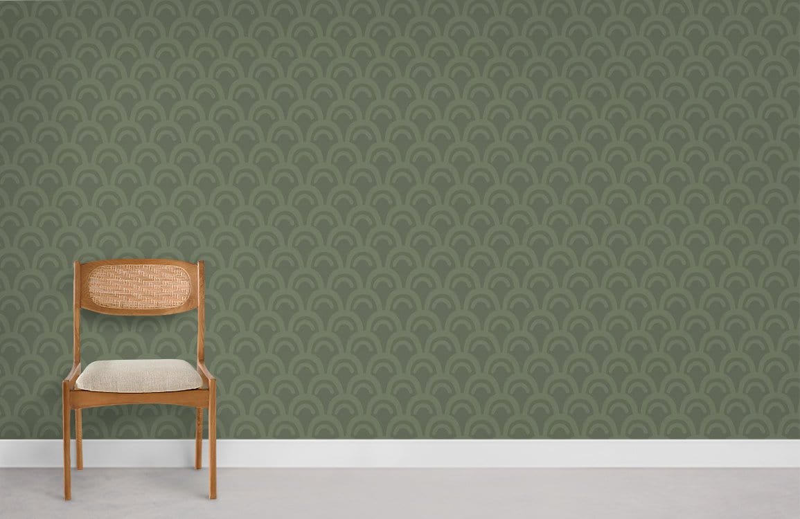 Elegant green Art Deco wallpaper enhances room with wooden chair, white skirting, and grey floor.