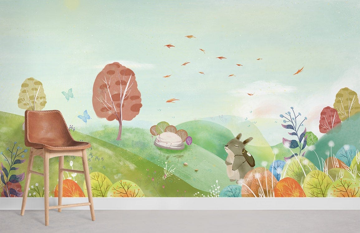 Whimsical Pastel Countryside Mural Wallpaper, leather chair, light wood flooring, colourful playful mural scene.