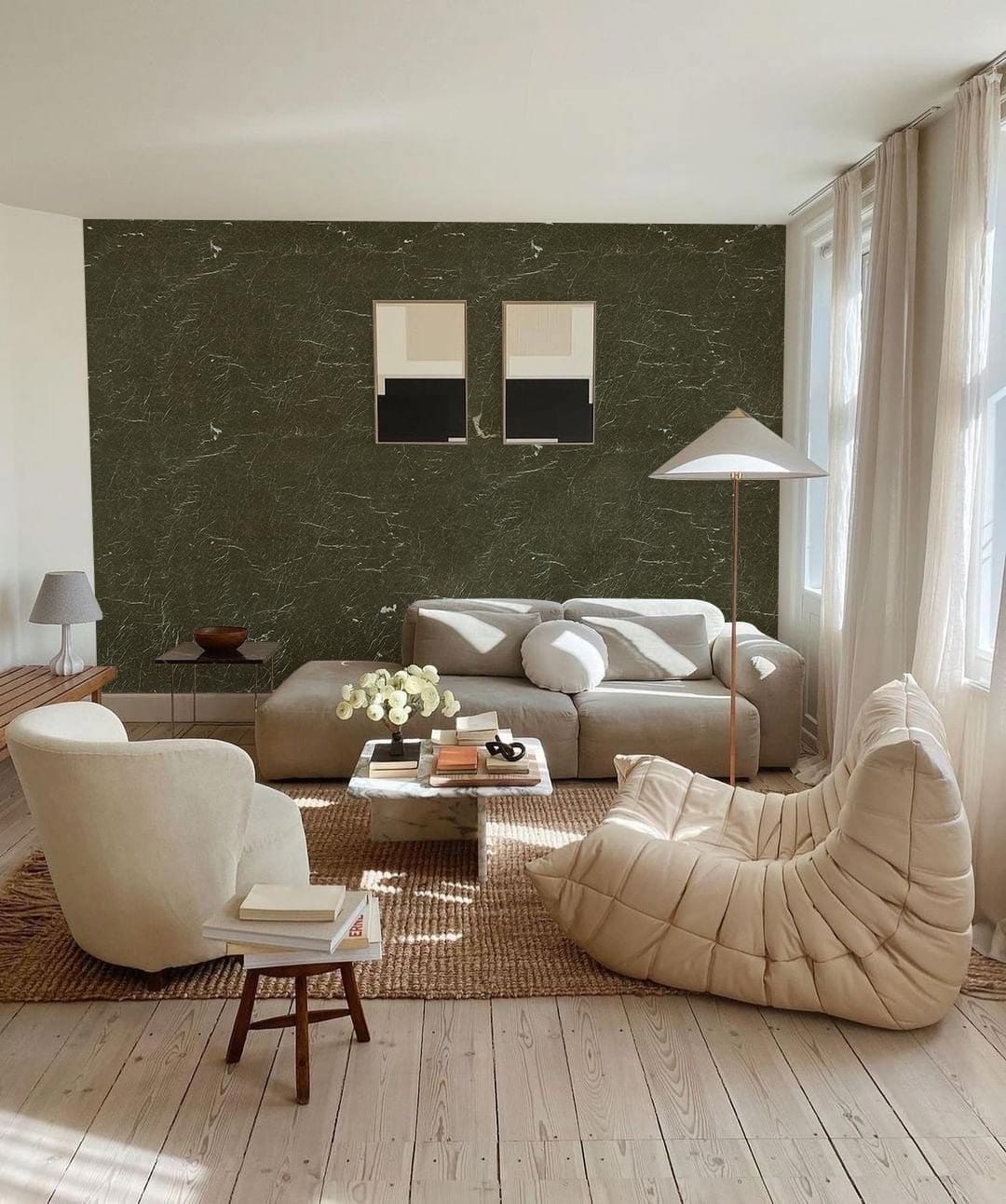 Living room with Elegant Dark Marble Wallpaper, cream sofa, armchair, beige flooring, and minimal decor.