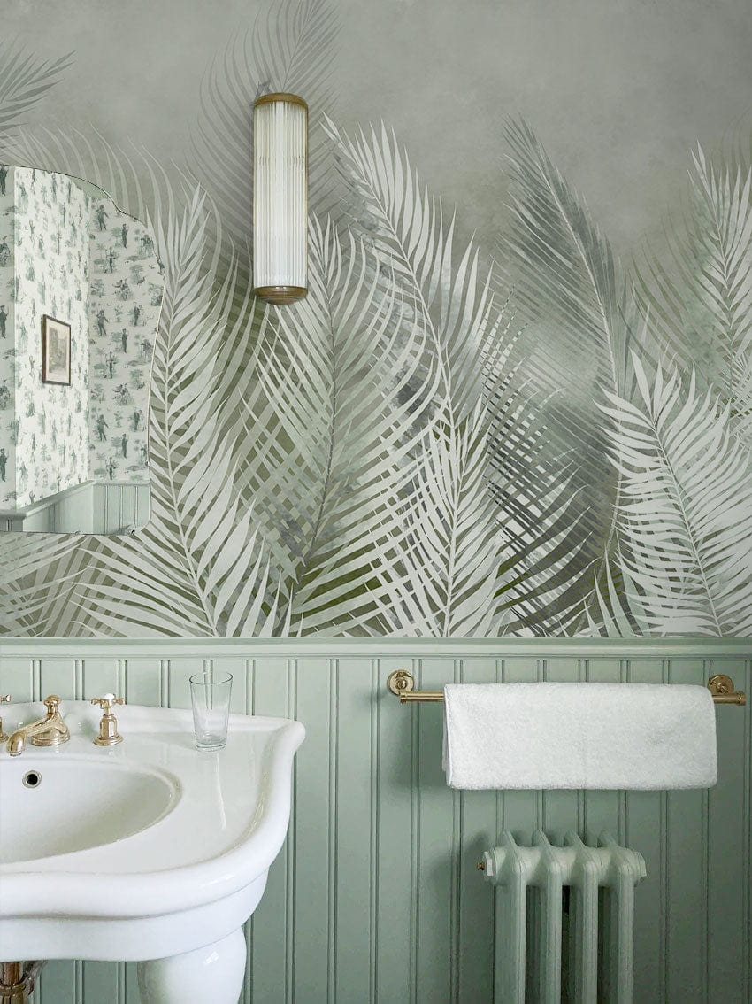 Tropical Misty Ferns Mural Wallpaper, green tones, bathroom sink, wall sconce, wainscoting, elegant decor.