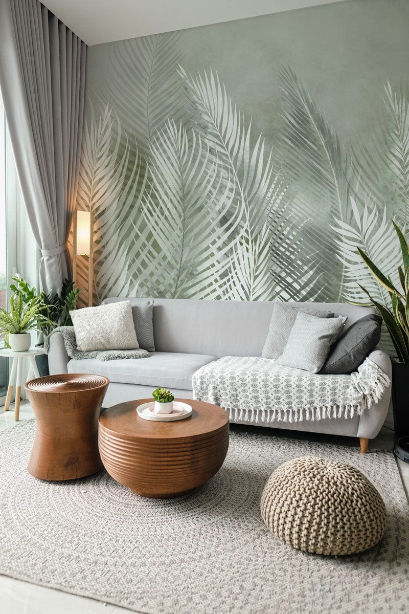 Tropical Misty Ferns Mural Wallpaper, grey sofa, wooden tables, cosy living room, green decor accents.
