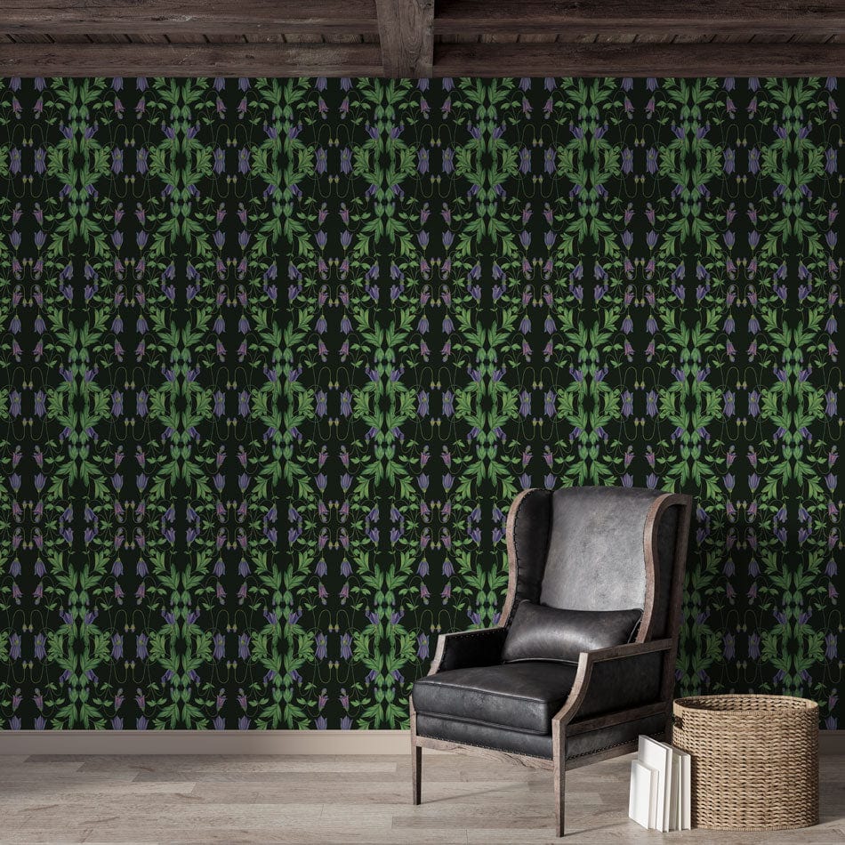 Dark botanical wallpaper, vibrant green foliage, elegant black armchair, wooden flooring, rustic room setting.