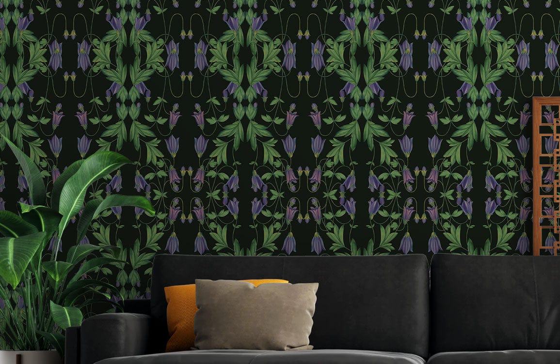 Dark botanical wallpaper with vibrant green foliage, featuring black sofa and wooden decor in a stylish room.