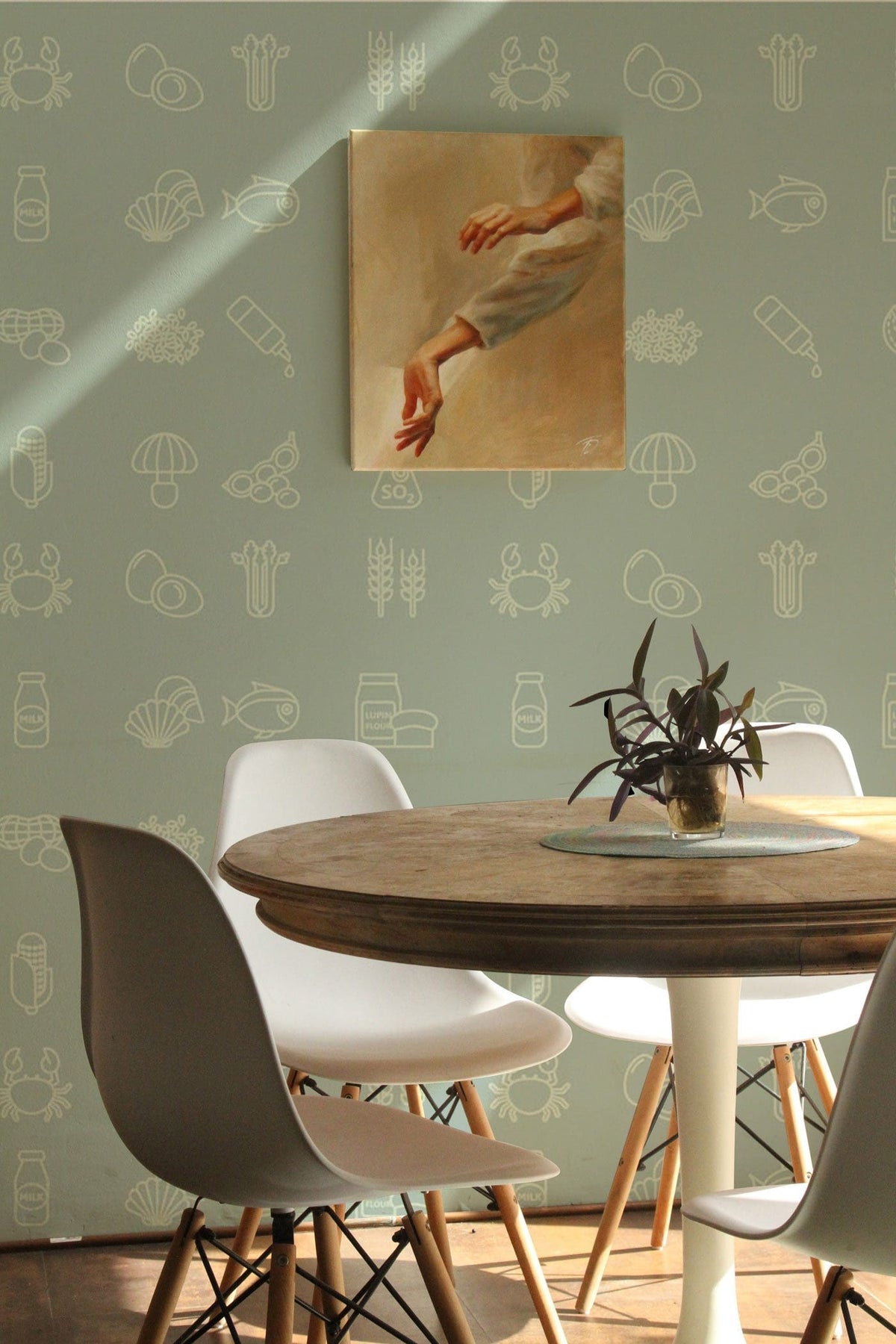 Pastel green wallpaper with nautical patterns, modern kitchen decor, white chairs, round wooden dining table.