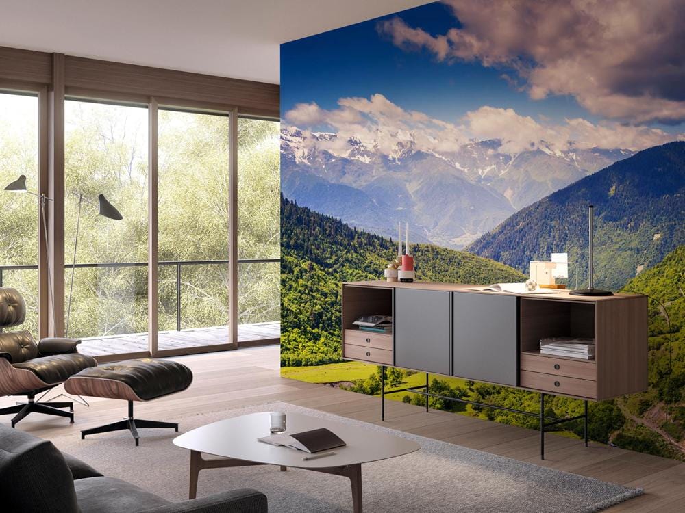 Scenic Mountain Valley Landscape Mural Wallpaper, modern room with grey sofa, wooden flooring, large windows.