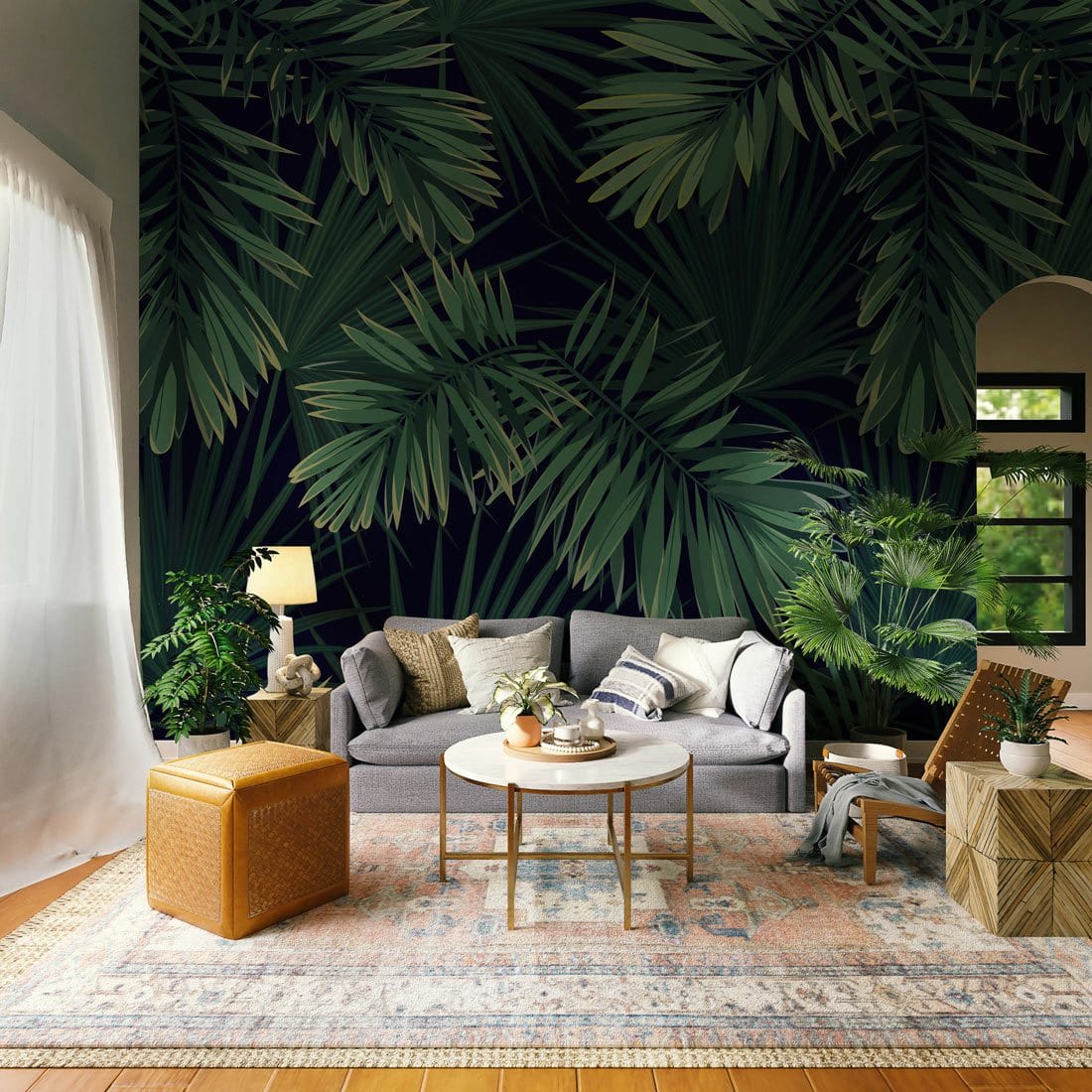 Tropical Green Palm Leaves Pattern Wallpaper in living room with grey sofa, wooden table, and rug.