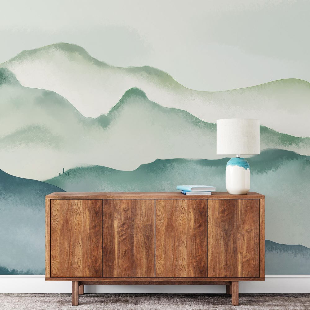 Elegant watercolour landscape mural wallpaper with wooden sideboard, lamp; Misty Mountain Serenity in tranquil room.