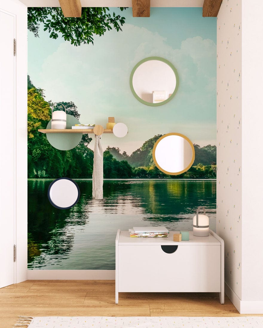 Tranquil Green Lake Reflection mural in living room with wood flooring, wall mirrors, and white cabinet.