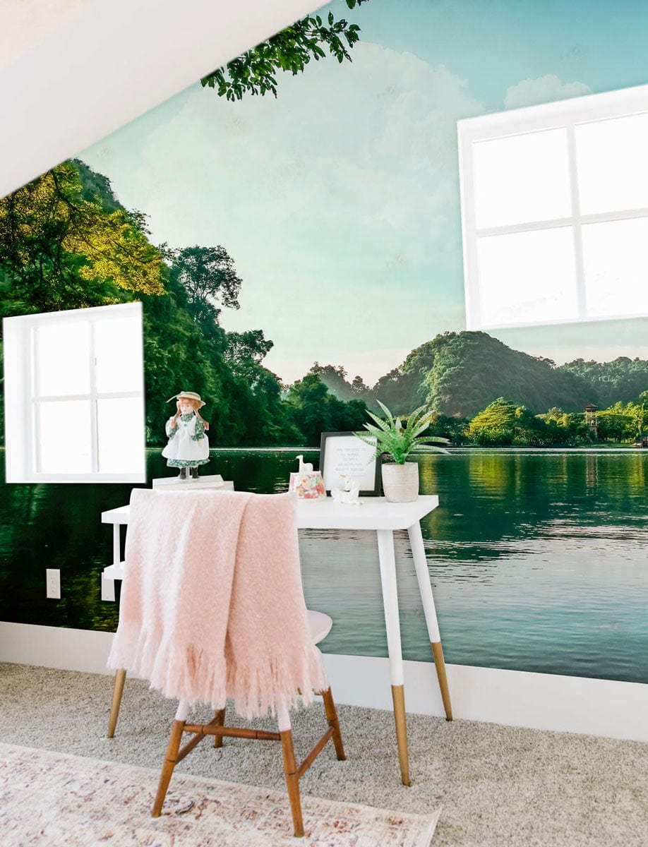 Tranquil green lake mural in modern white office with pink throw, carpet flooring, and scenic view.