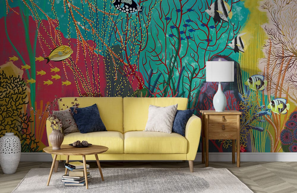 Tropical Underwater Paradise mural with vibrant coral, yellow sofa, wooden table, grey herringbone flooring.