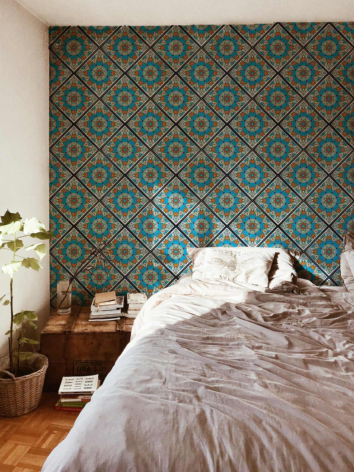 Vibrant Turquoise and Orange Mediterranean Tile Pattern Wallpaper in cosy bedroom with wooden flooring.