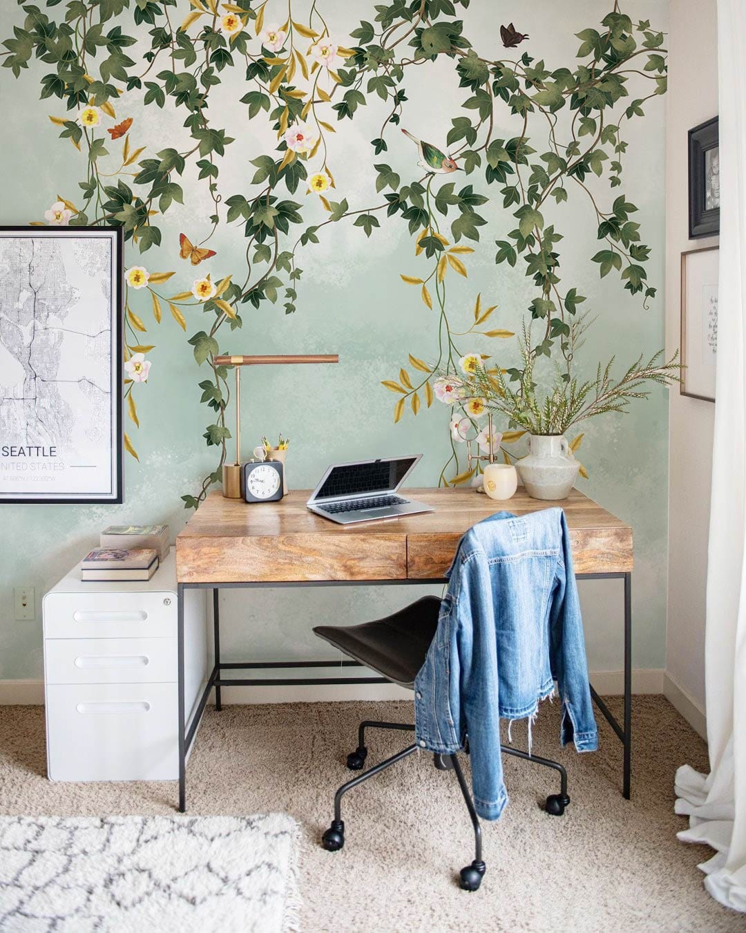 Chic study room with vintage green floral vines wallpaper, modern desk, stylish chair and lush carpet.