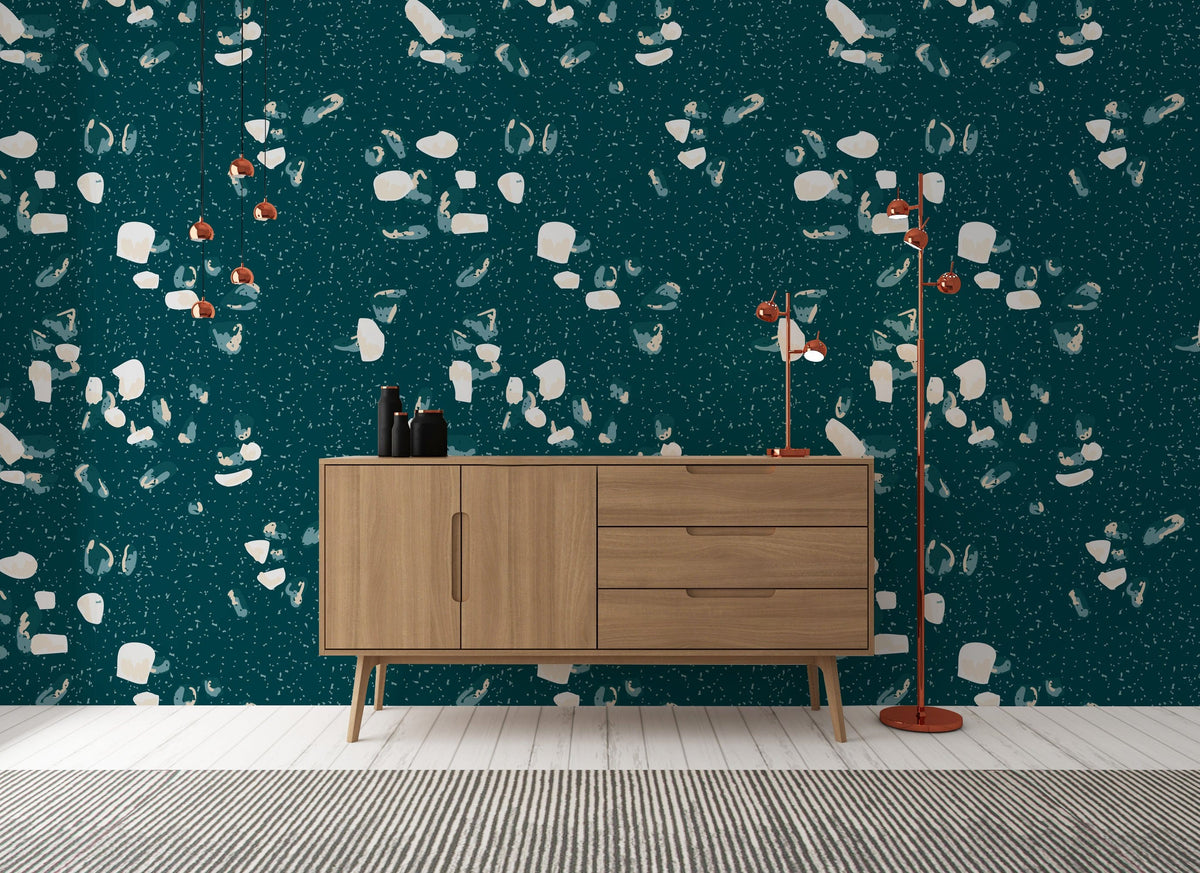 Elegant deep green abstract wallpaper, mid-century wooden sideboard, white floorboards, orange floor lamp.