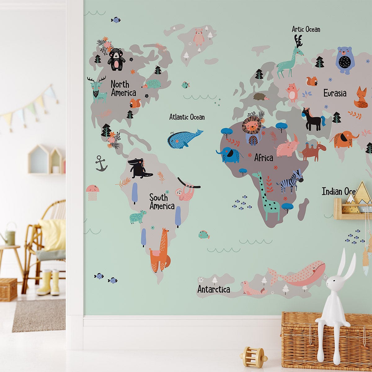 Playful Animal World Map Mural Wallpaper in child's room, mint green wall, wooden chair, soft rug.