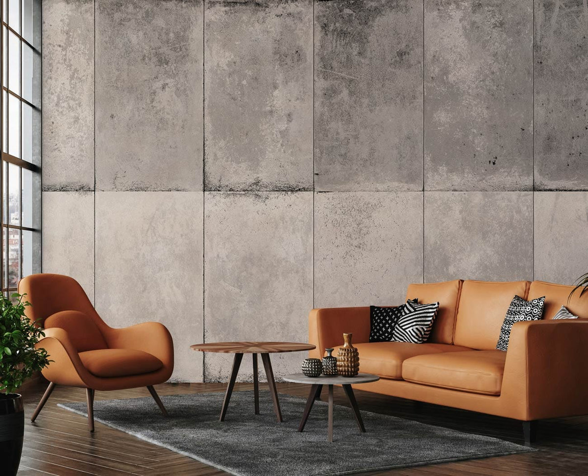 Industrial grey concrete effect wallpaper with rustic urban style, tan leather sofa, wooden flooring.