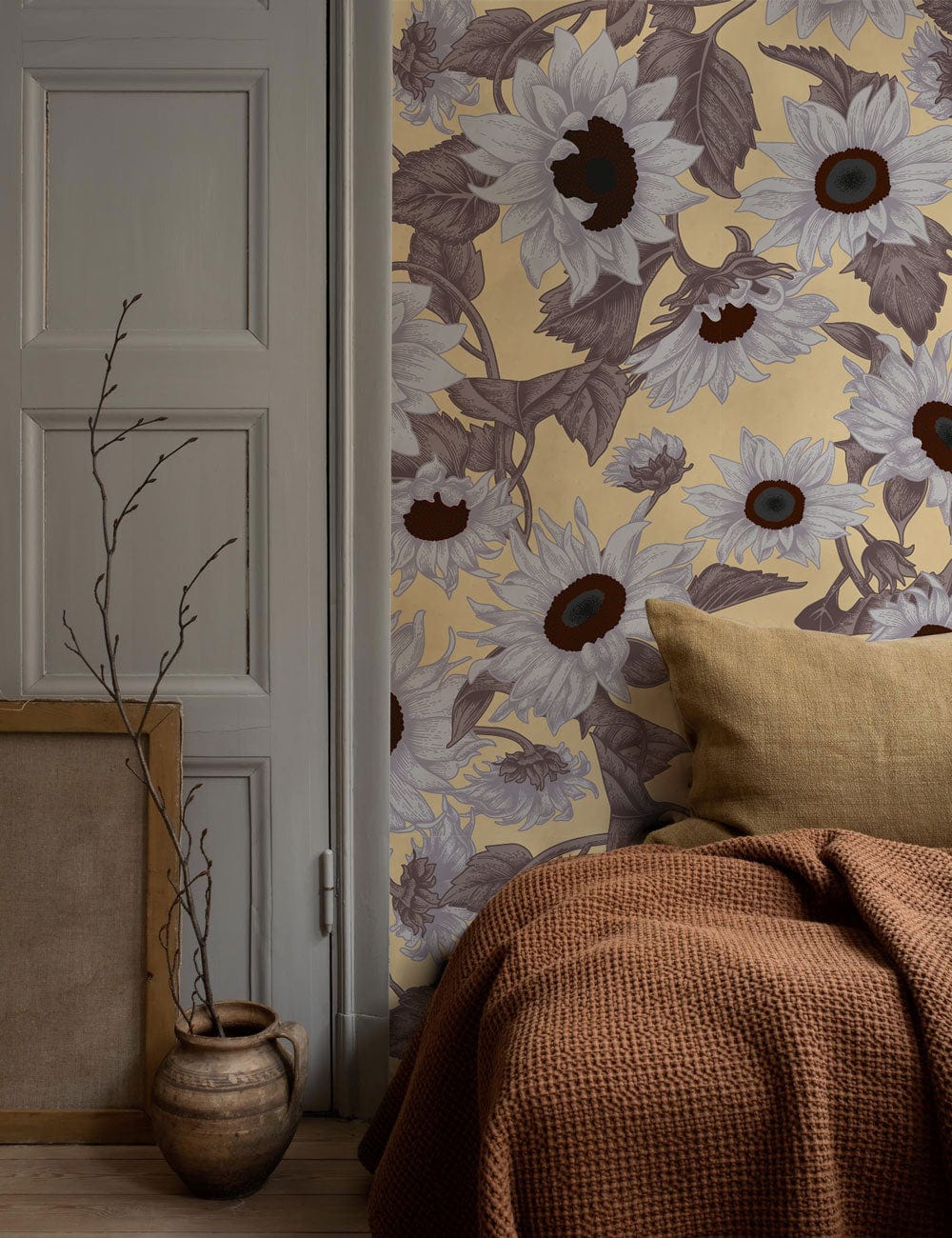 Vintage sunflower floral wallpaper, beige-brown design; cosy room with brown knitted sofa blanket.