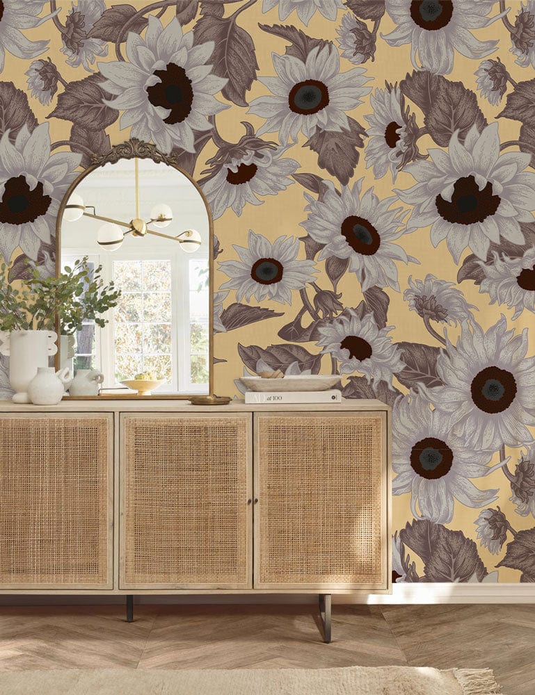Vintage Sunflower wallpaper design, beige and brown floral pattern, rattan sideboard, arched mirror, wooden floor.