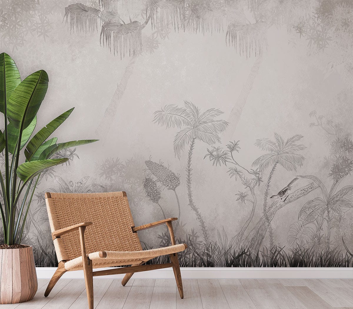 Graceful monochrome tropical mural wallpaper, elegant botanical design, wicker chair, light wood flooring, potted plant.